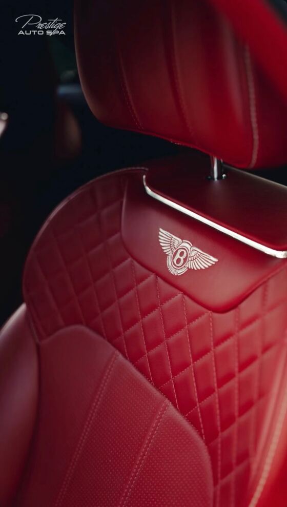 Red diamond-quilted leather seat with the Bentley wings embroidered on the headrest