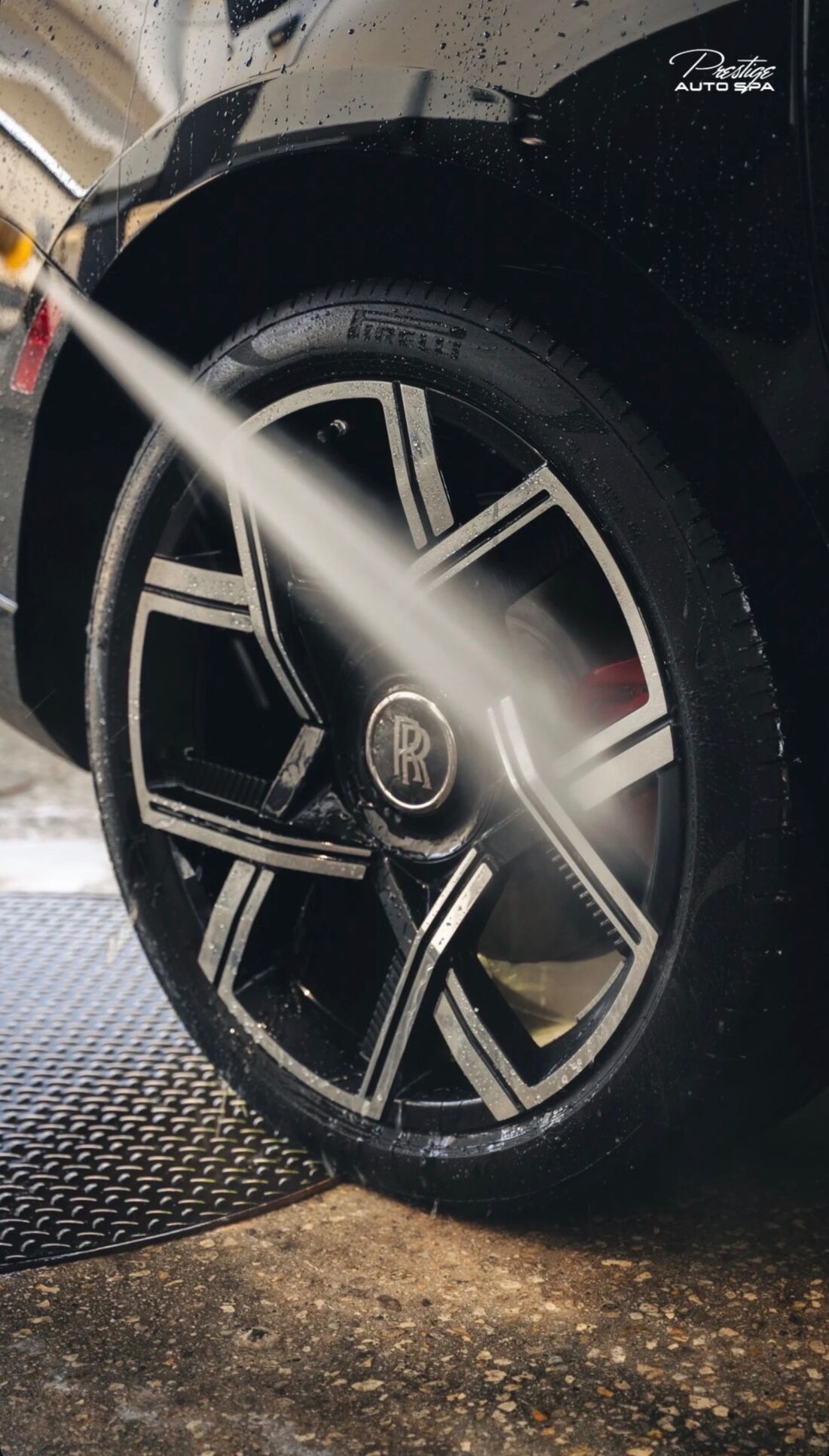 Water jet rinsing a Rolls-Royce wheel with a Pirelli tire